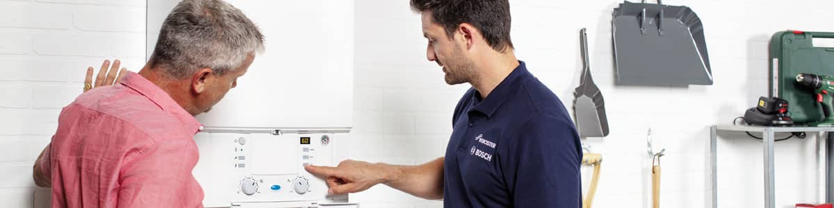 Plumber demonstrating new boiler to customer