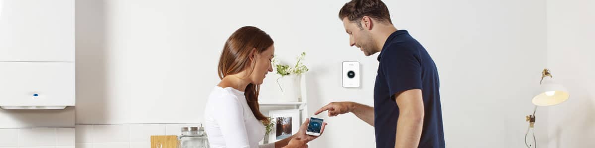 Woman using new boiler smart controls