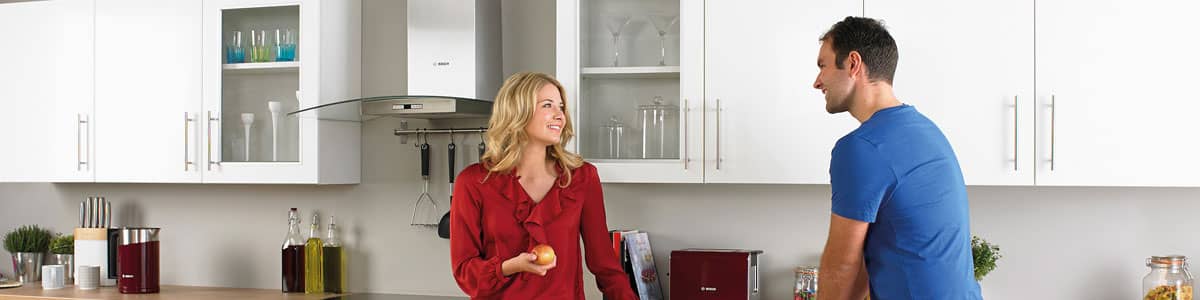 Couple with oil boiler installed in kitchen