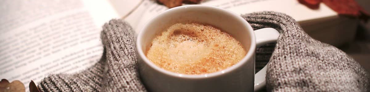 Coffee mug with gloves and Autumn leaves