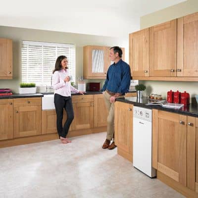 Man and woman in kitchen in Wrexham with new oil boiler installed